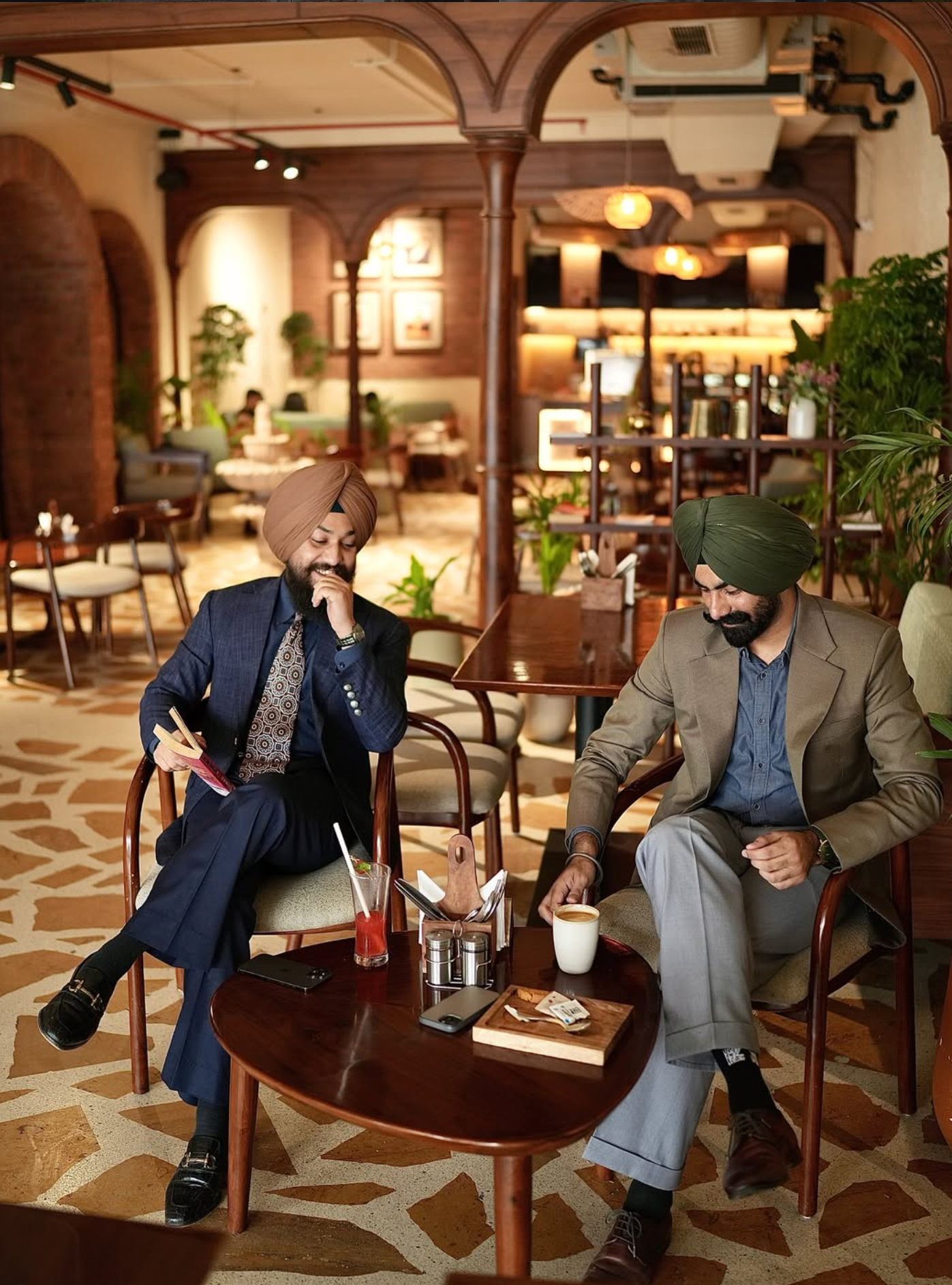 Two men in Hamees Attire tailoring, seated in an Amritsar café